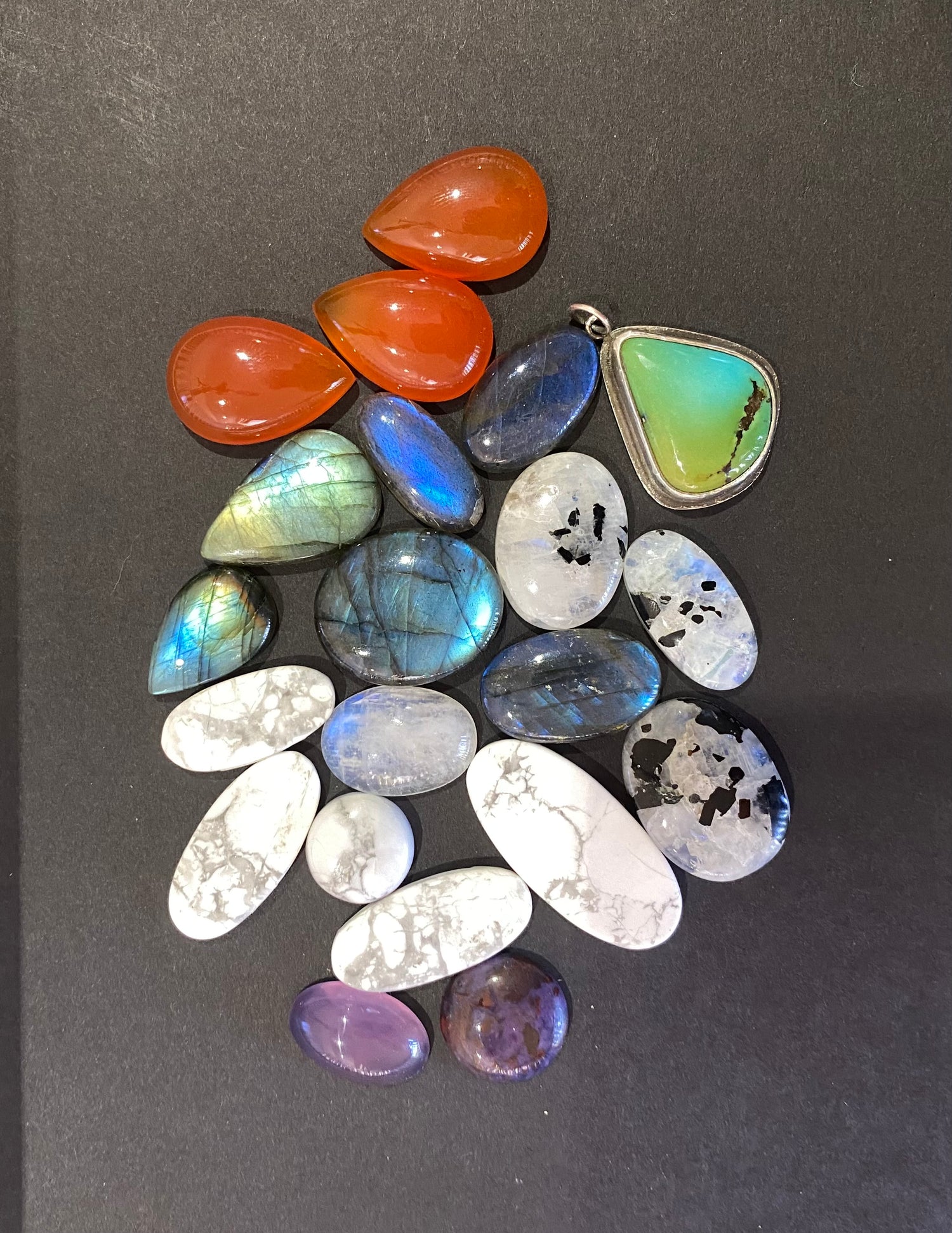 Collection of various gemstones on a black background