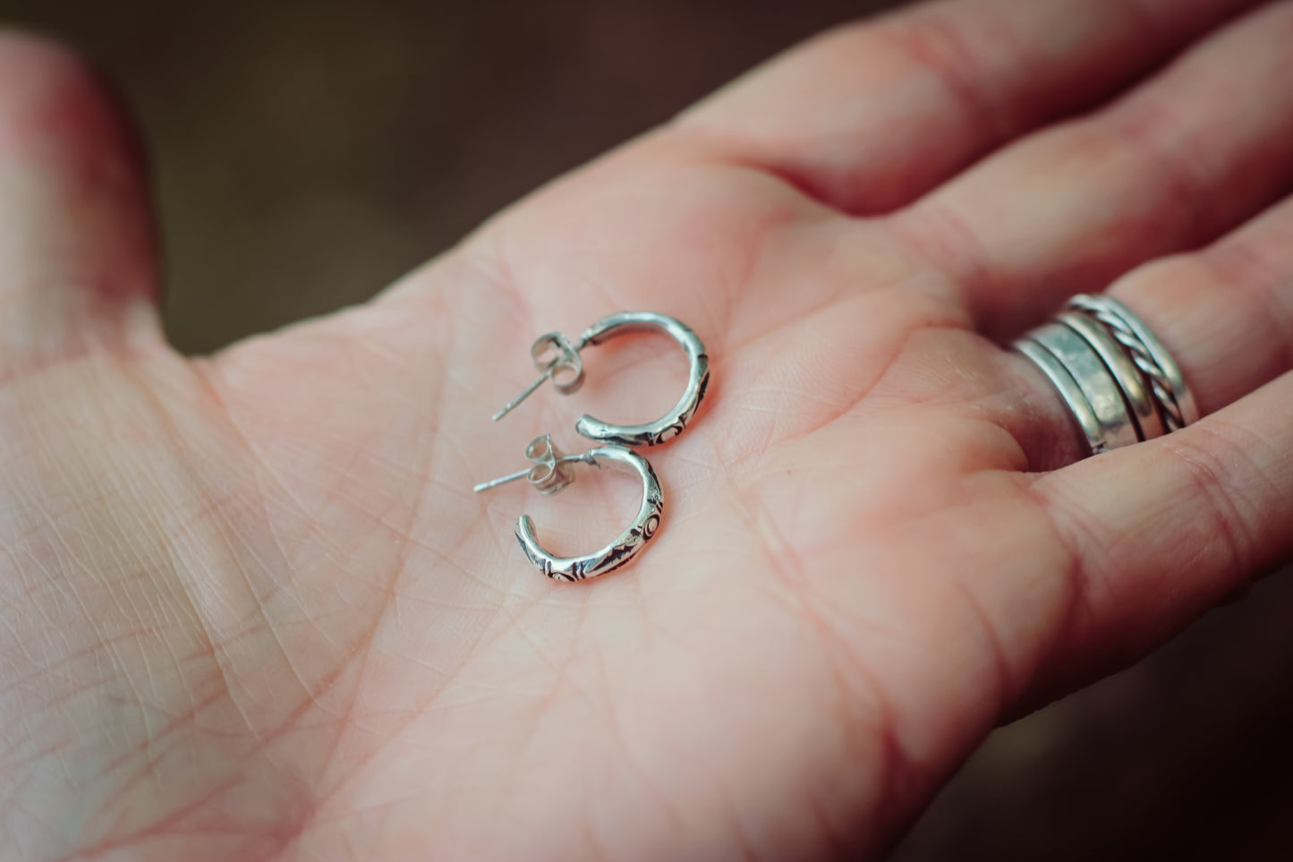 Silver artisan hoops in hand