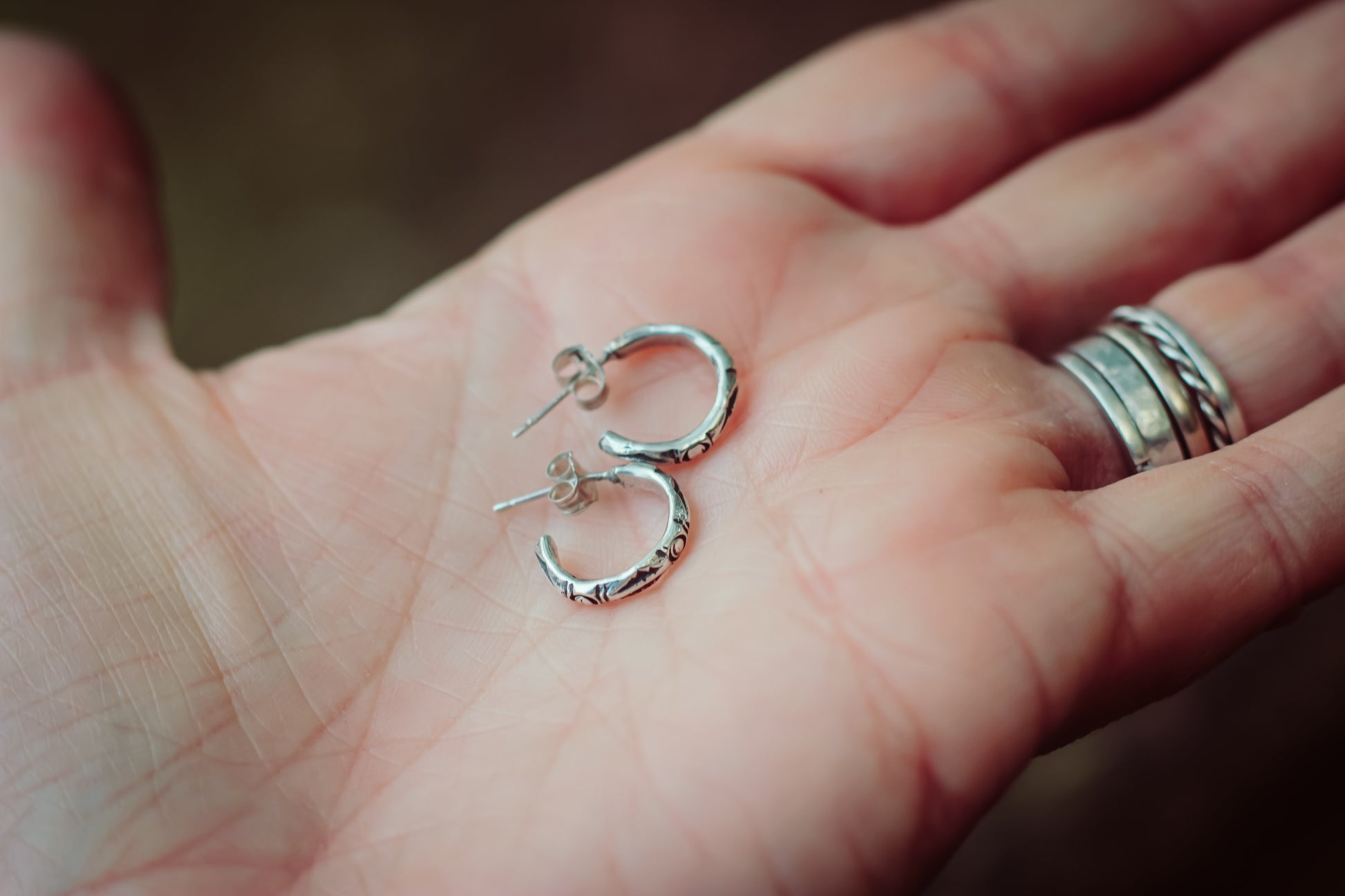 Silver artisan hoops in hand