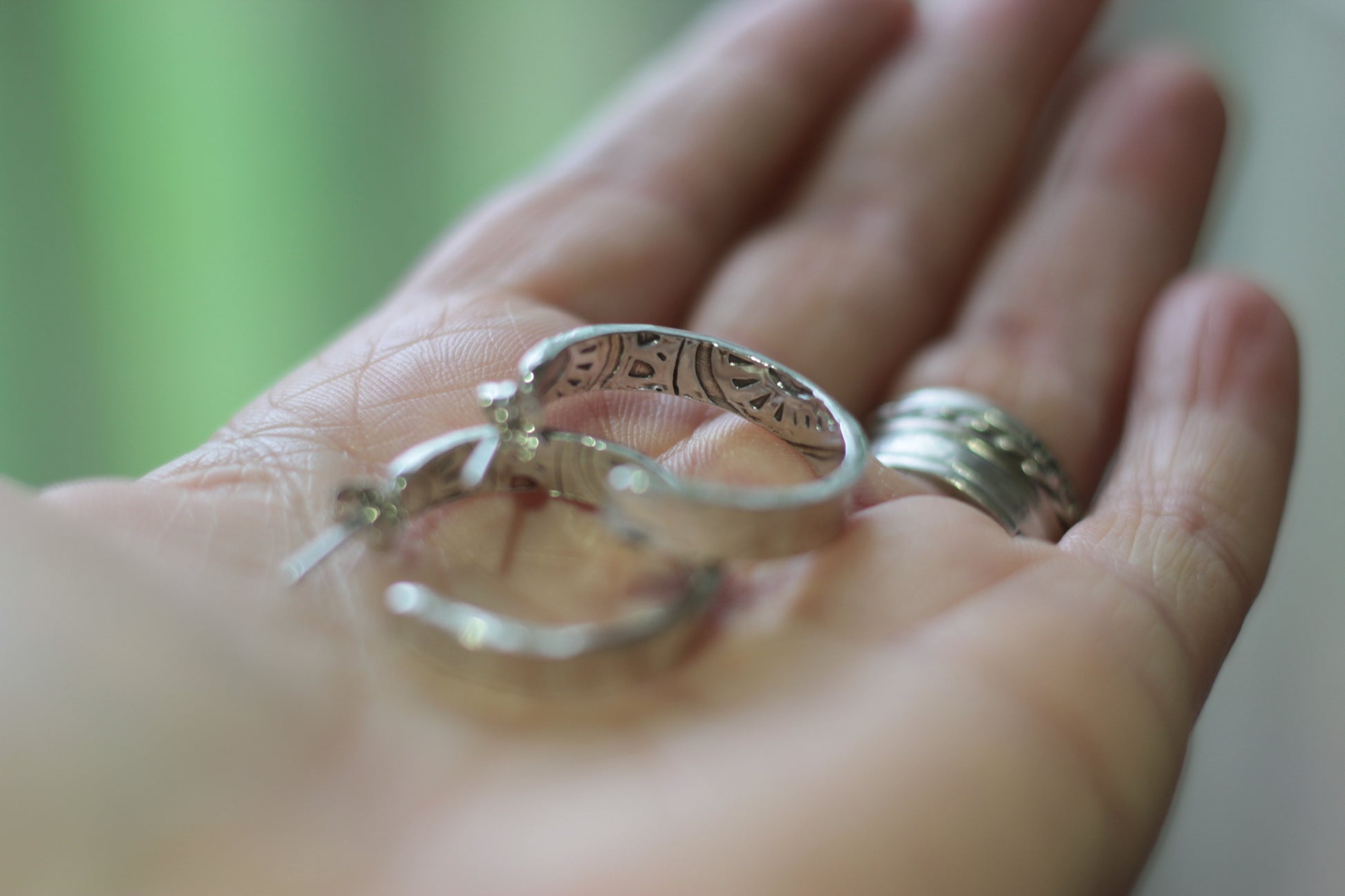 Large boho silver artisan hoops in hand