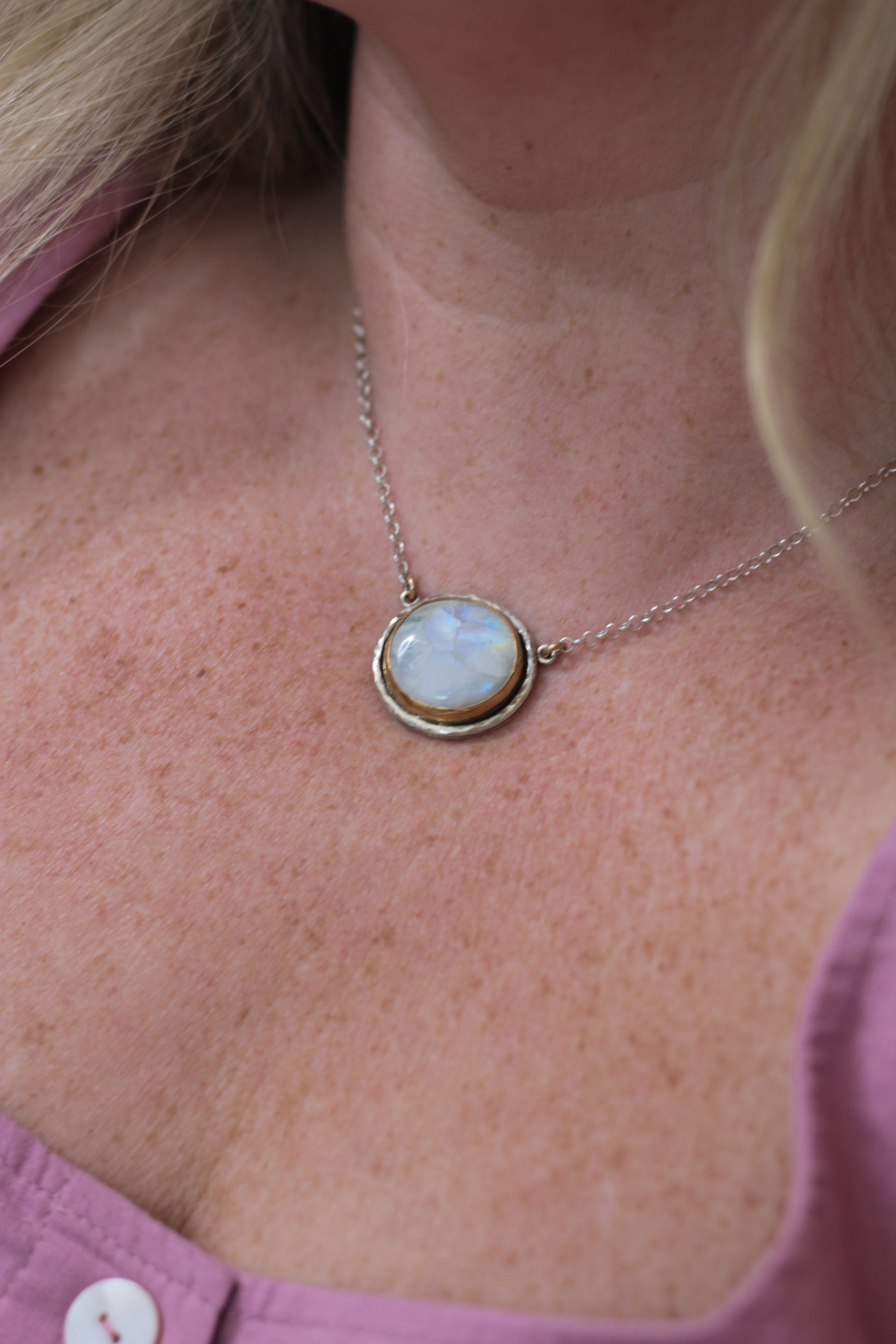 Necklace with a pendant worn by a person, close-up view.
